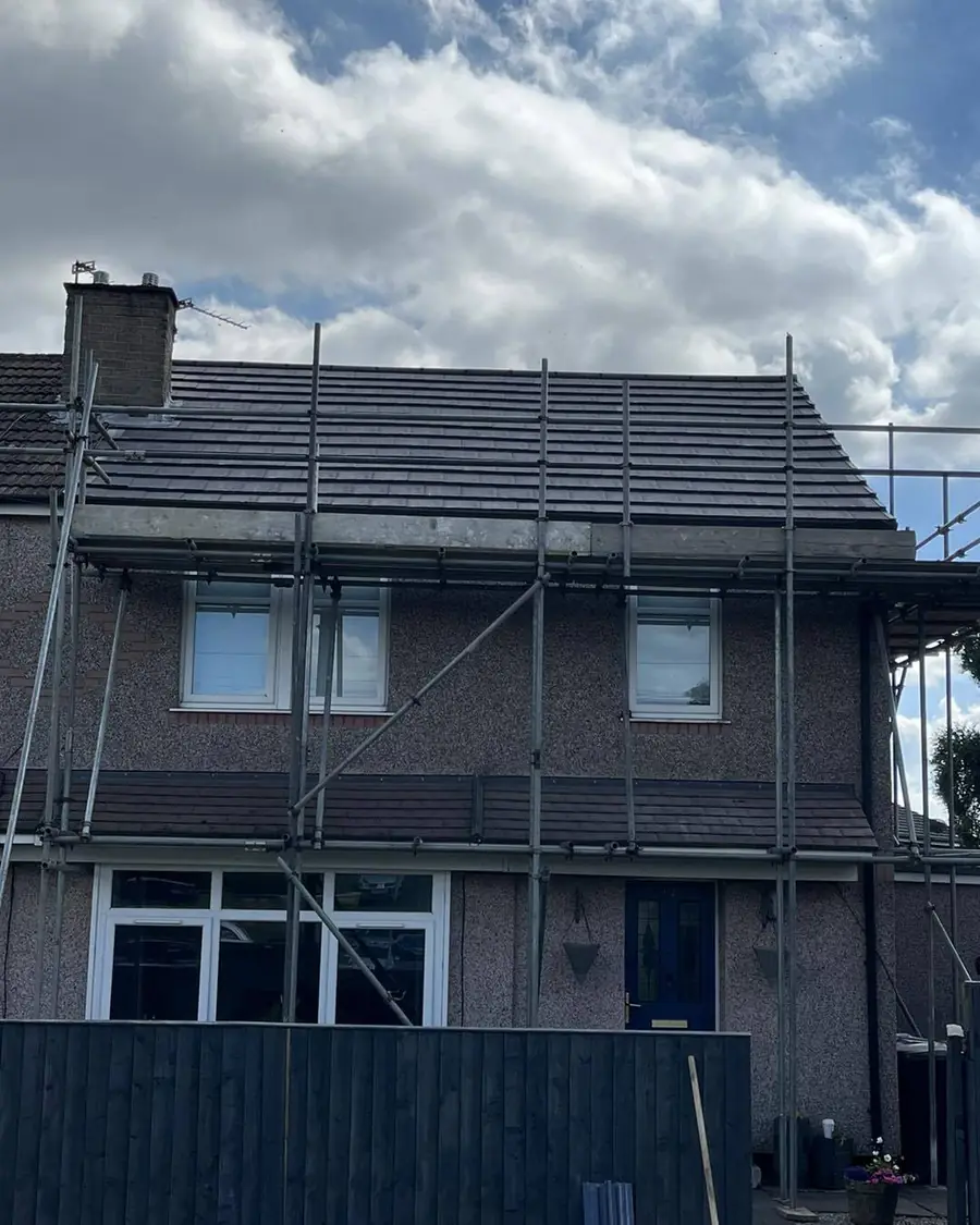 Brick semi-detached house fully scaffolded for roof work