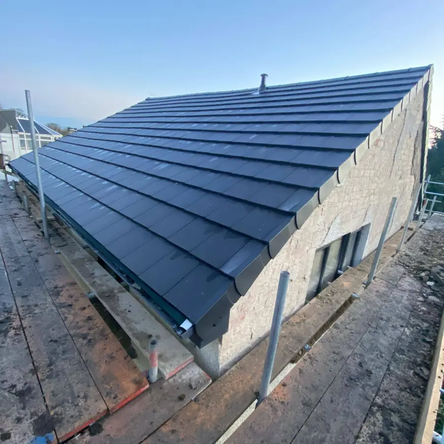 Dark grey tiled gable roof finished at the verge