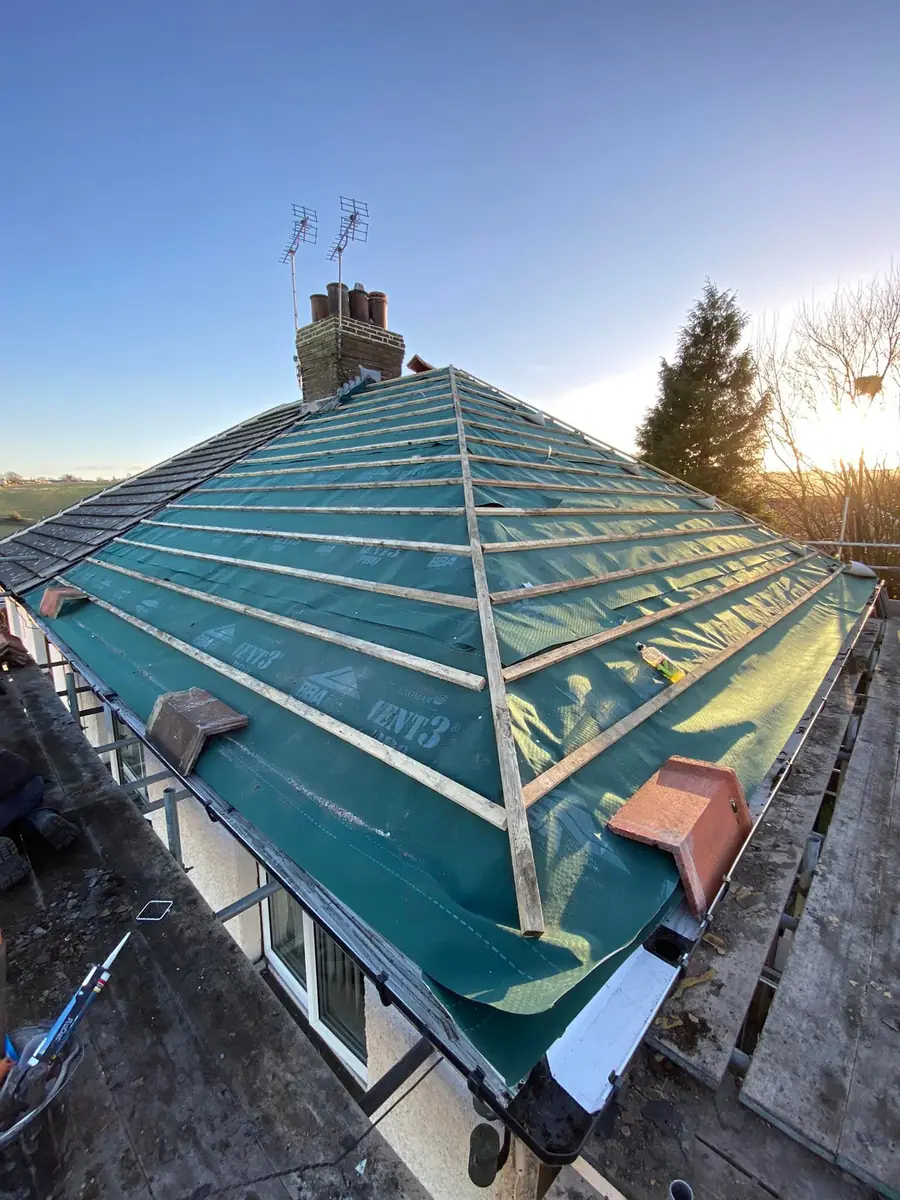 Hip roof covered in new green membrane and battens before the tiles go on