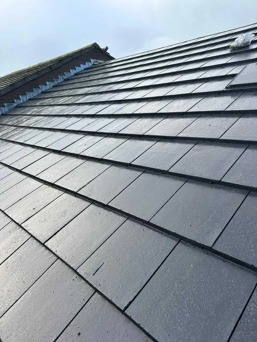 Grey tiled roof slope, close view of the coursing