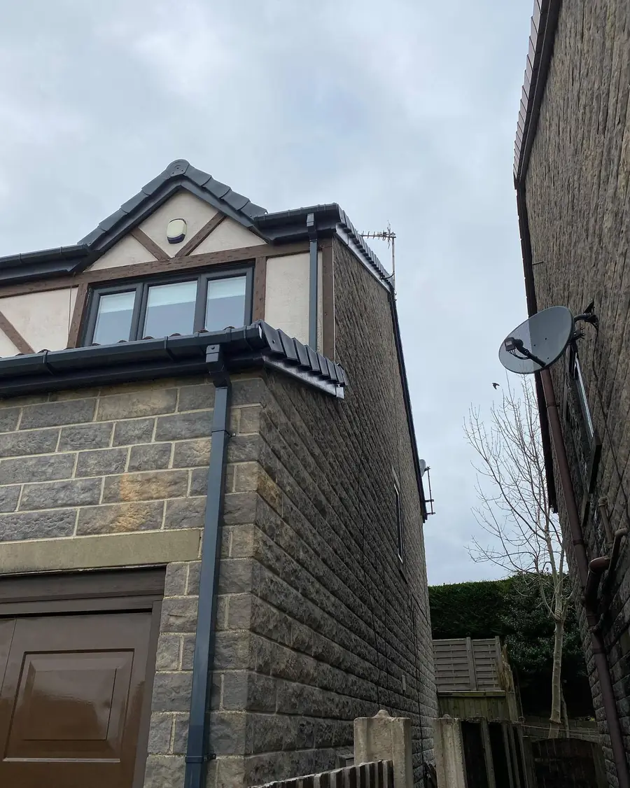 New gutters and downpipe on a stone-built extension