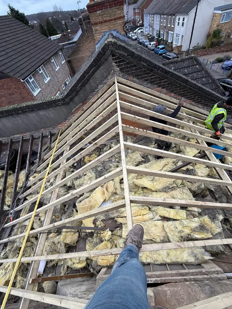Old roof covering removed down to the rafters, measuring up before the new membrane goes on