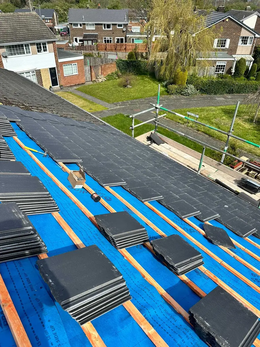Tiles loaded out on new blue membrane and battens, ready to lay